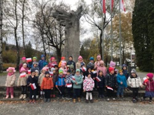 Dzieci stoją przed pomnikiem "Poległym i walczącym" w Wiśle