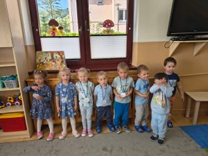 Maluchy pozują w sali do zdjęcia, na szyi mają. Medale